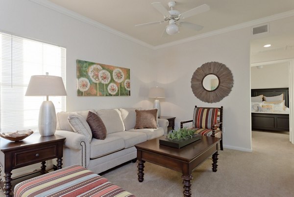 Living room with modern decor and natural light at The Ravinia Apartments, luxury living in a Greystar community