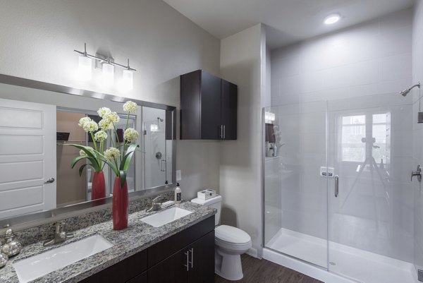 Bathroom featuring sleek fixtures and modern design at High Point Uptown Apartments