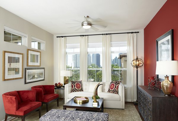 Spacious living room with contemporary decor in High Point Uptown Apartments, featuring modern furnishings and abundant natural light