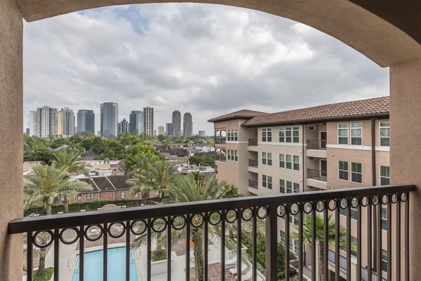 Private patio at High Point Uptown Apartments with comfortable seating and downtown views, ideal for luxury living