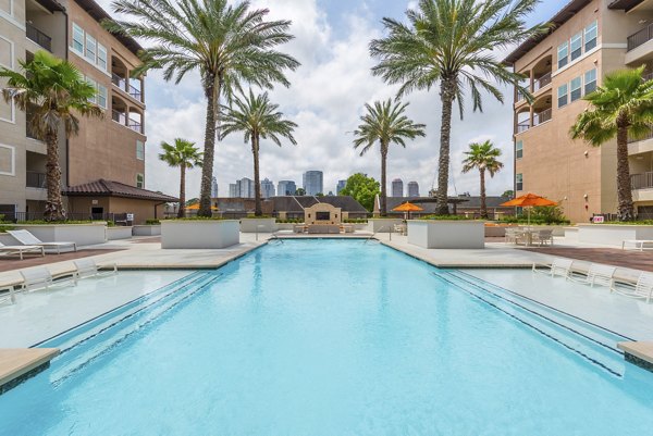 Luxury swimming pool with cabanas at High Point Uptown Apartments, perfect for relaxation and entertainment