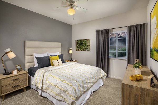 Elegant bedroom with large window and modern decor at The Heights at Chino Hills Apartments