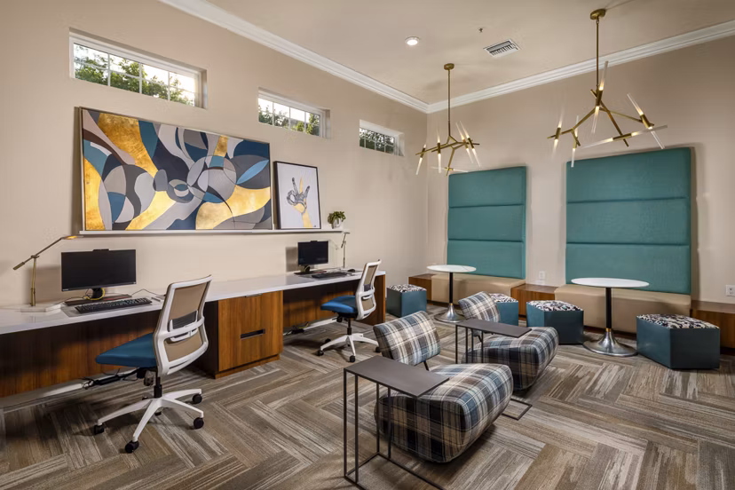 Modern business center with workstations at The Heights at Chino Hills Apartments, offering a professional environment for residents