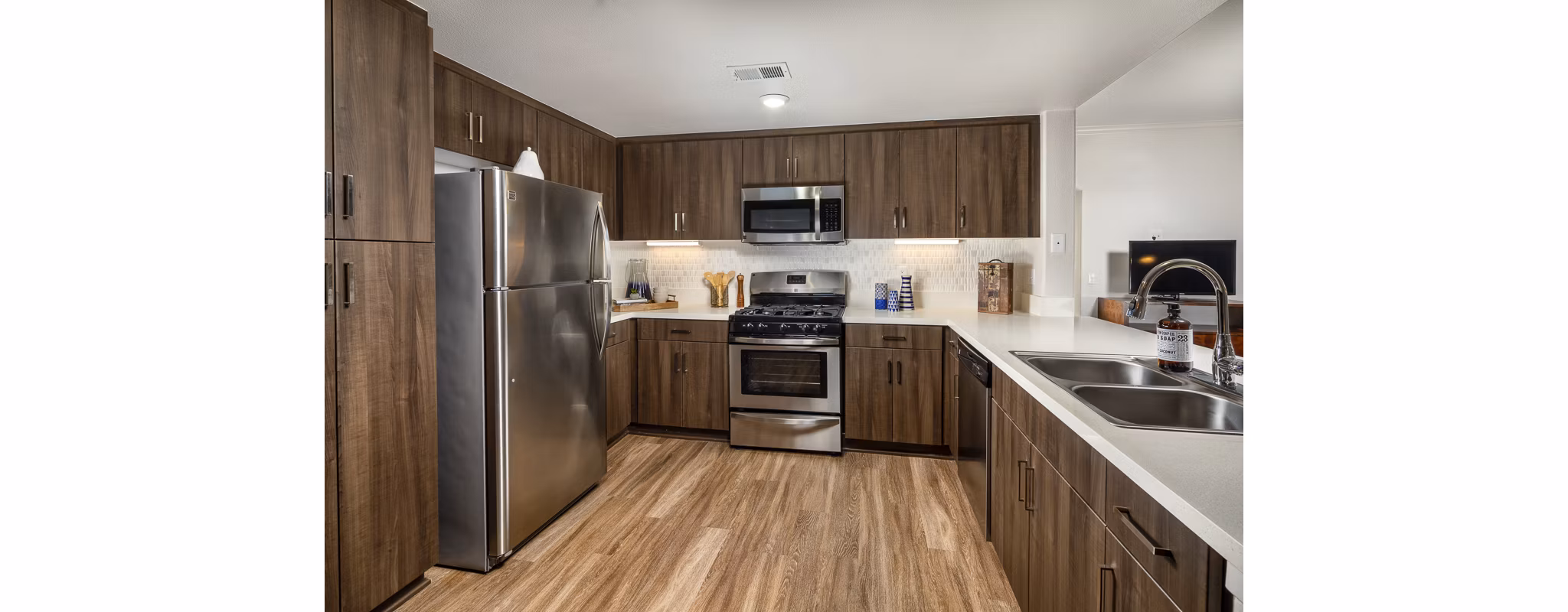 Modern kitchen with stainless steel appliances at The Heights at Chino Hills Apartments, offering luxury living space