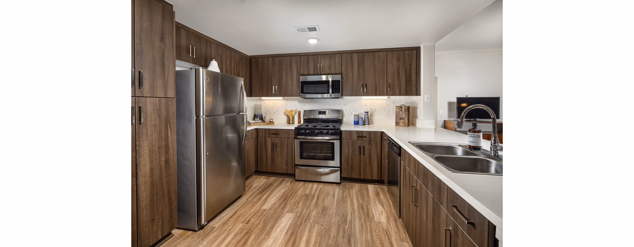 Modern kitchen with stainless steel appliances at The Heights at Chino Hills Apartments, offering luxury living space