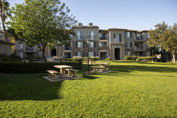 Outdoor grill area ideal for gatherings at The Heights at Chino Hills Apartments, featuring modern amenities and seating options for residents