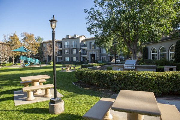 Grill area with modern seating at The Heights at Chino Hills Apartments patio