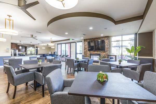 Clubhouse dining area with modern seating and decor at Overture Central Park Apartments, luxury living in Colorado Springs