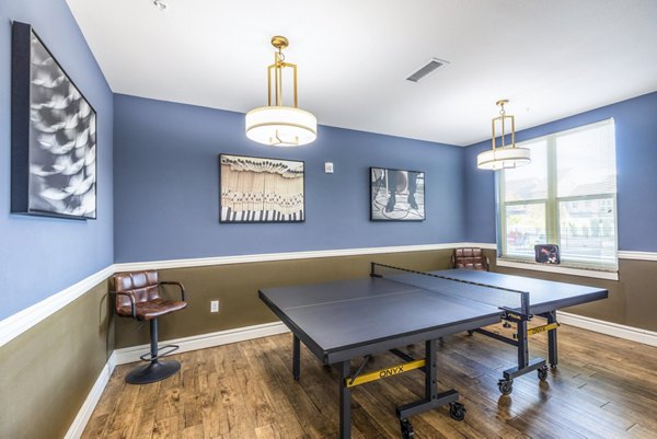 Indoor table tennis area with modern equipment at Overture Central Park Apartments, offering recreational space at luxury Greystar apartments