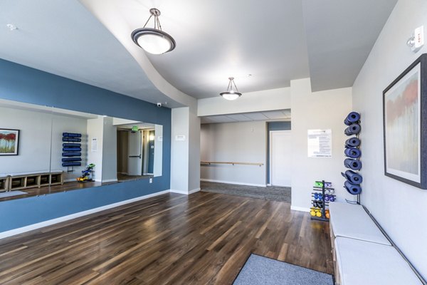 Yoga studio with serene ambiance at Overture Central Park Apartments, offering a peaceful retreat for luxury living