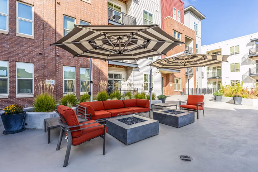 Inviting fire pit and furnished patio at Overture Central Park Apartments, ideal for outdoor relaxation and social gatherings