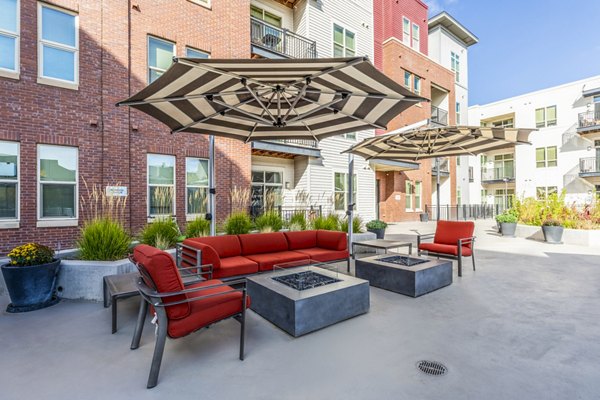 Inviting fire pit and furnished patio at Overture Central Park Apartments, ideal for outdoor relaxation and social gatherings