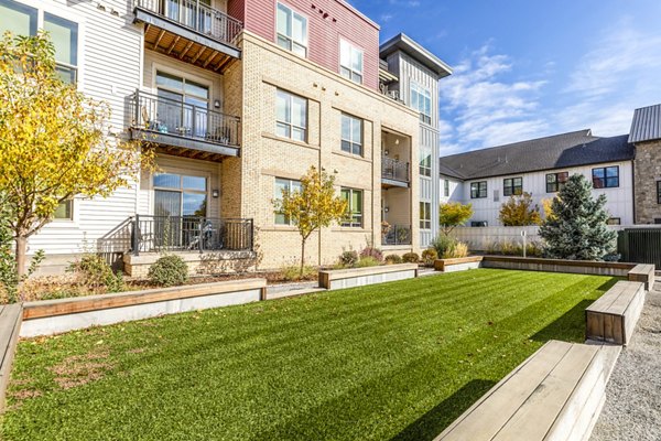 Courtyard with lush landscaping and seating area at Overture Central Park Apartments, offering luxury living in a serene setting
