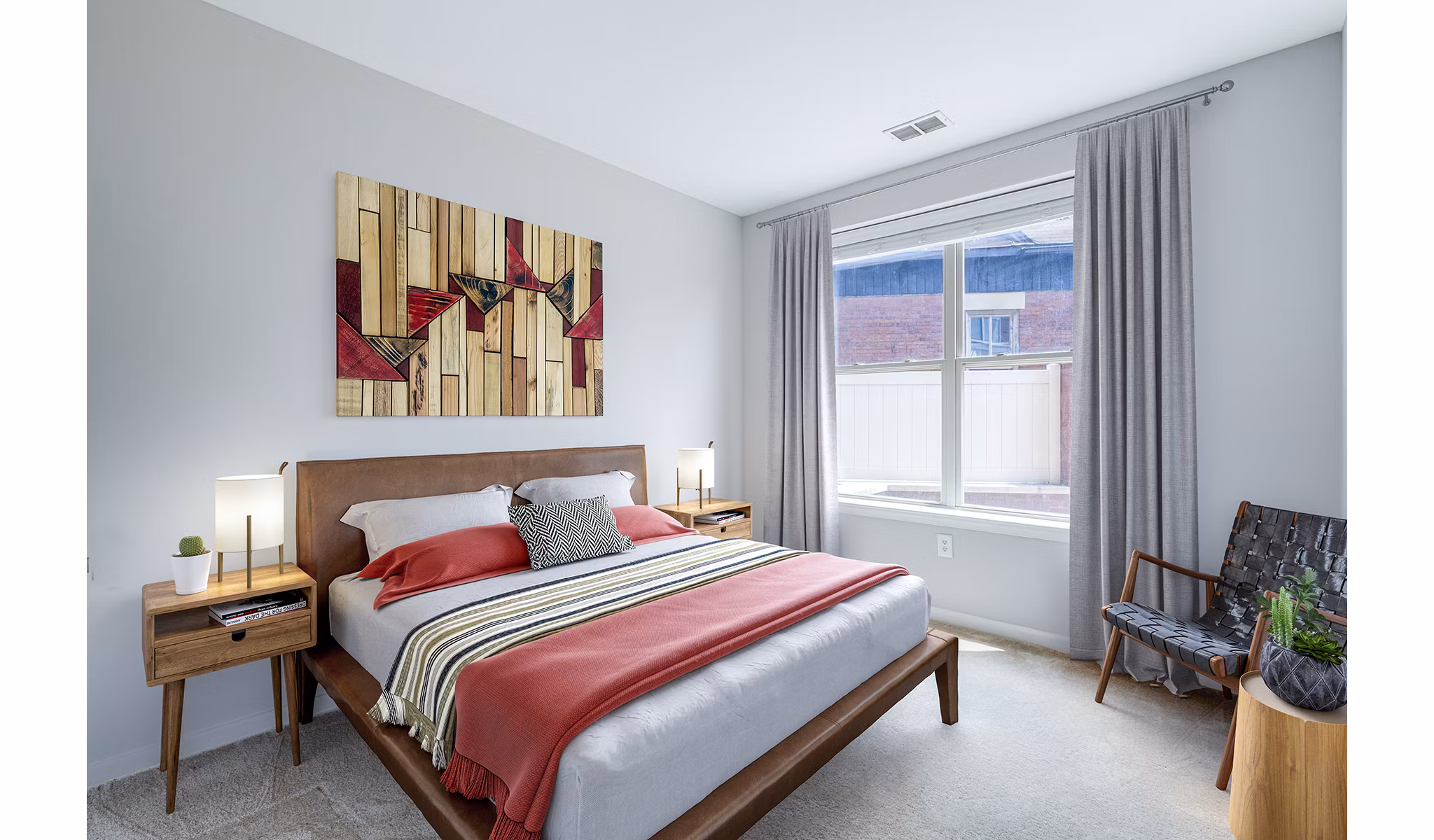 Tranquil bedroom with modern decor at Rutherford Station Apartments, offering serene space for luxury living in prime location