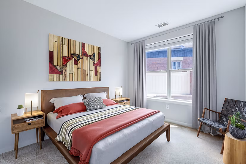 Tranquil bedroom with modern decor at Rutherford Station Apartments, offering serene space for luxury living in prime location