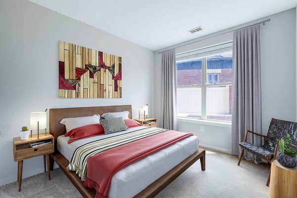 Tranquil bedroom with modern decor at Rutherford Station Apartments, offering serene space for luxury living in prime location