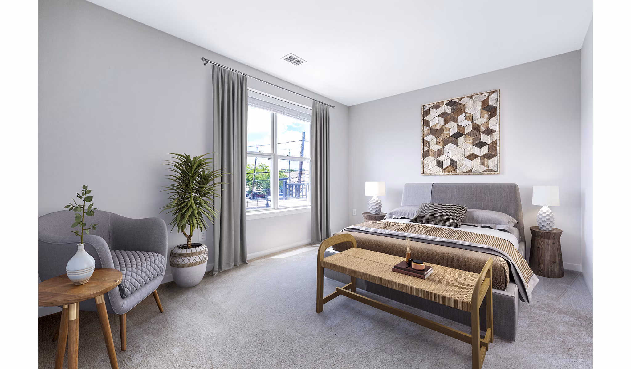 Cozy bedroom with modern decor at Rutherford Station Apartments, featuring a plush bed and stylish furnishings