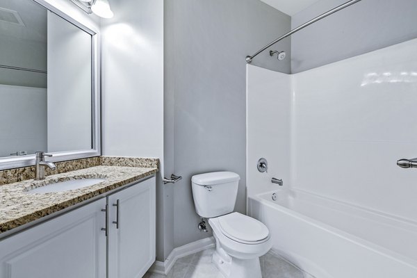Modern bathroom featuring sleek fixtures and tile design at Rutherford Station Apartments