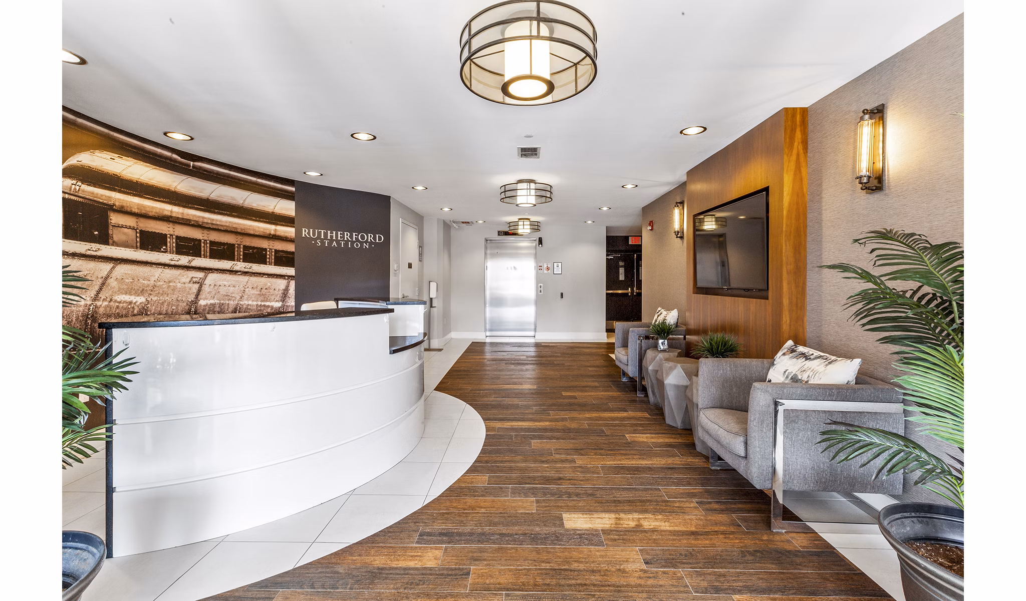 Welcoming lobby with modern design at Rutherford Station Apartments, featuring comfortable seating and sleek front desk