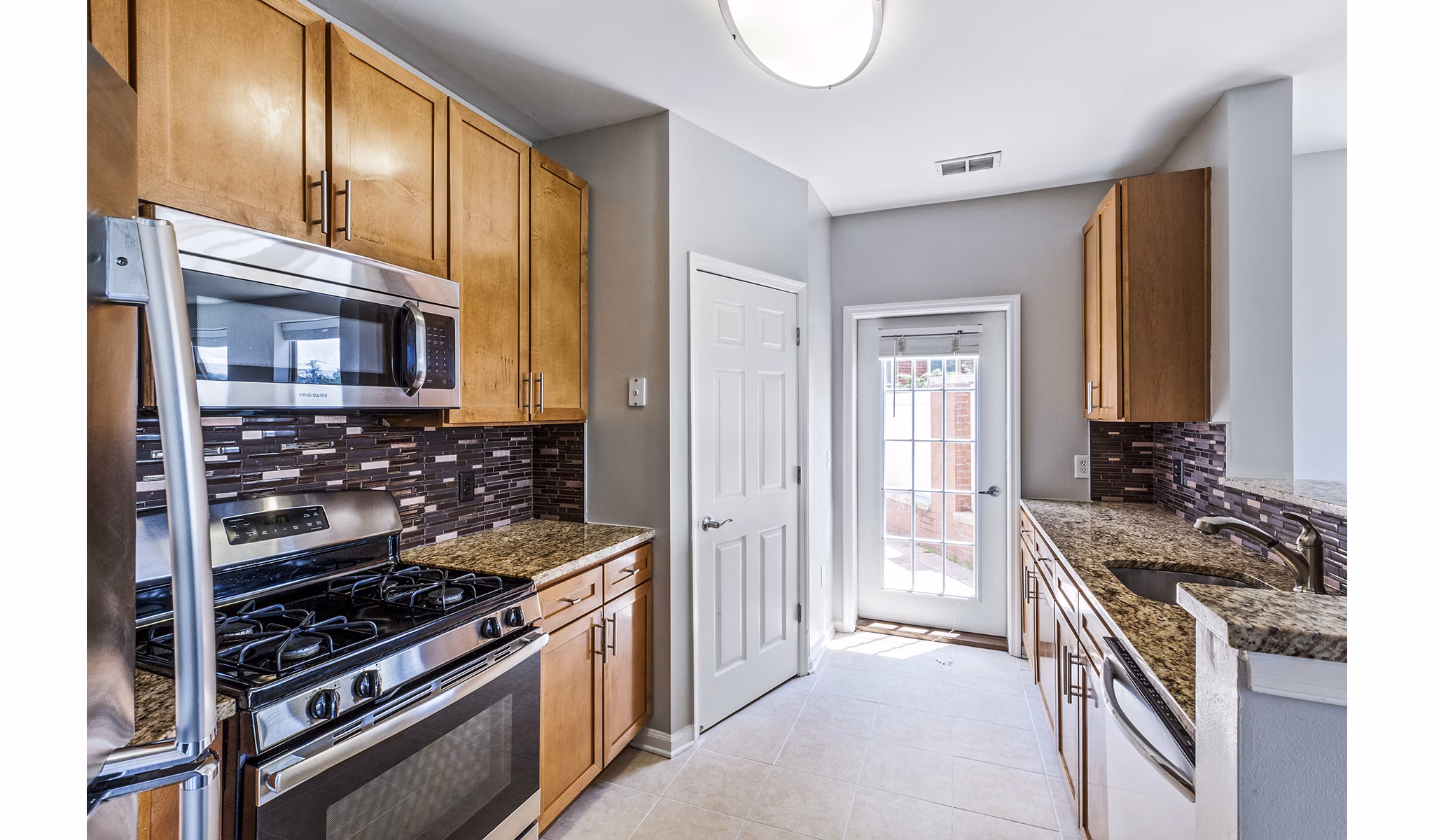 Contemporary kitchen with stainless steel appliances in Rutherford Station Apartments