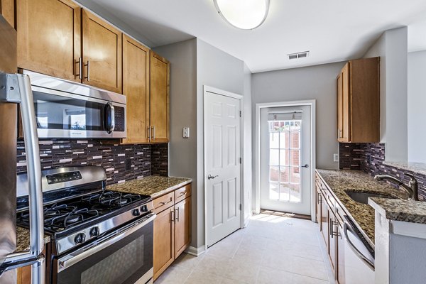 Contemporary kitchen with stainless steel appliances in Rutherford Station Apartments