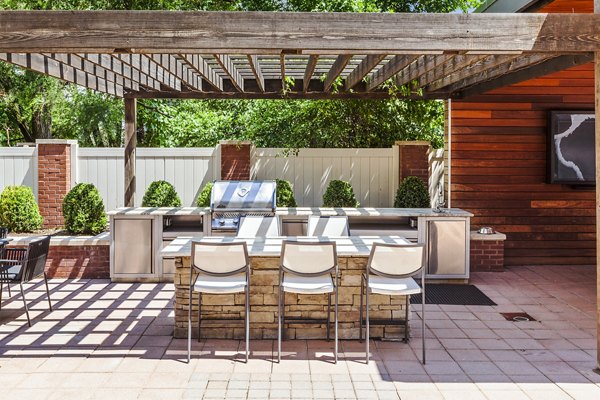 Grill area with modern seating at Rutherford Station Apartments, a luxury community by Greystar