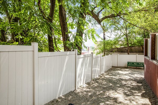 Spacious dog park with agility equipment at Rutherford Station Apartments, offering outdoor activities for pet-friendly living