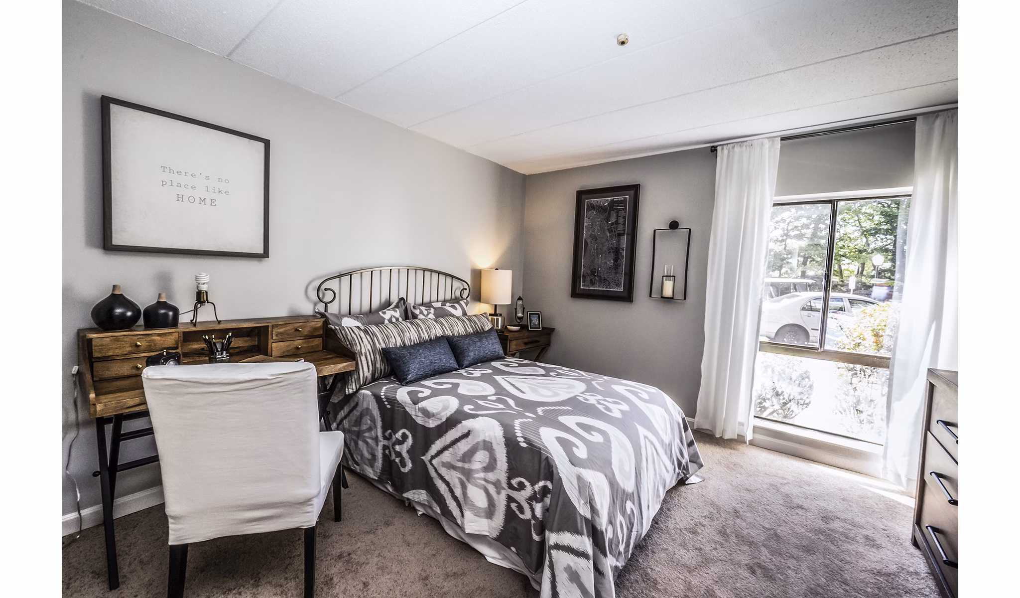 Cozy bedroom with natural light at Avana Weymouth Apartments, featuring plush bedding and modern furnishings