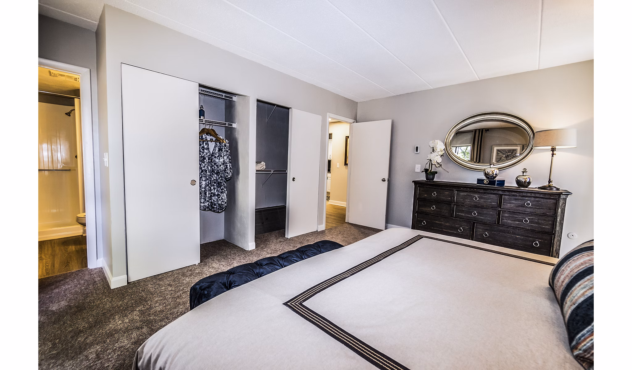 Spacious bedroom with natural lighting and modern decor at Avana Weymouth Apartments