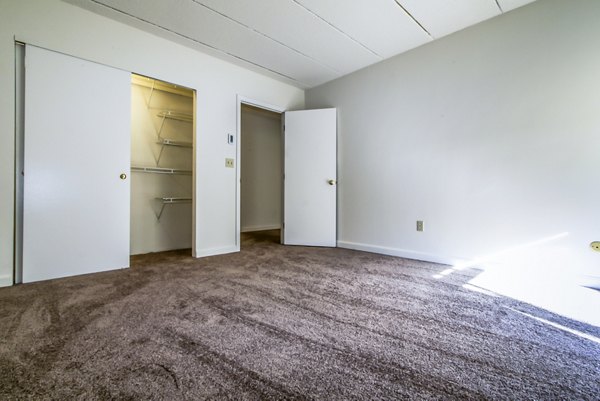 Bedroom with modern furnishings and large windows at Avana Weymouth Apartments