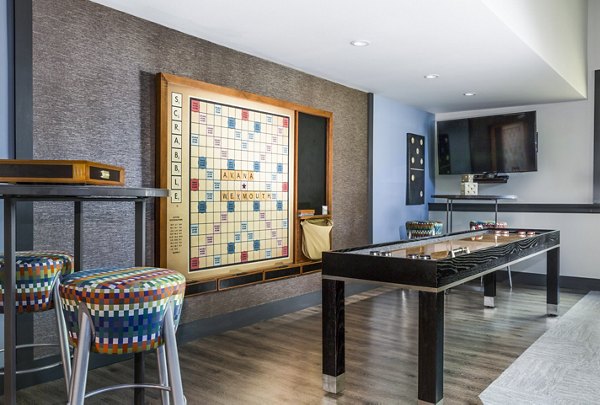 Modern game room with pool table and seating at Avana Weymouth Apartments