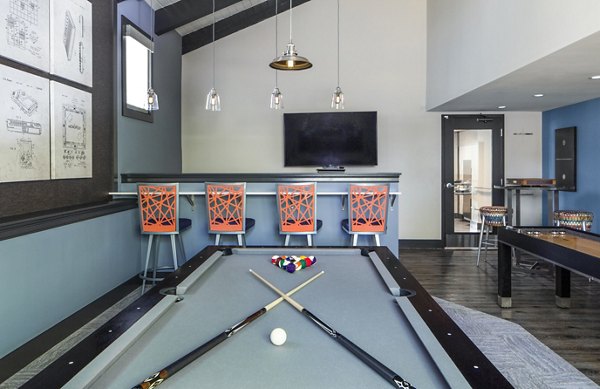 Game room with billiards and lounge seating at Avana Weymouth Apartments offering entertainment and relaxation options for residents