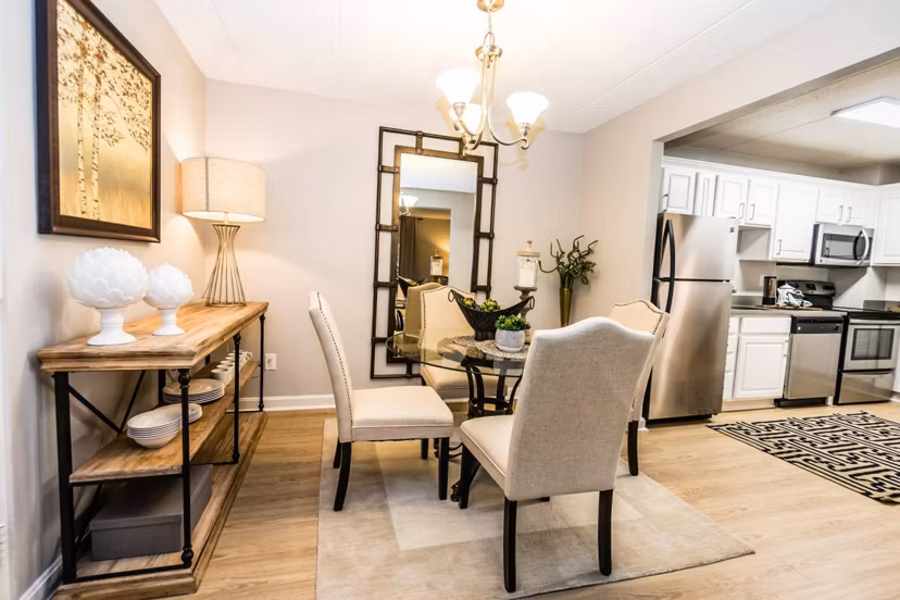 Dining room with modern decor and large windows at Avana Weymouth Apartments