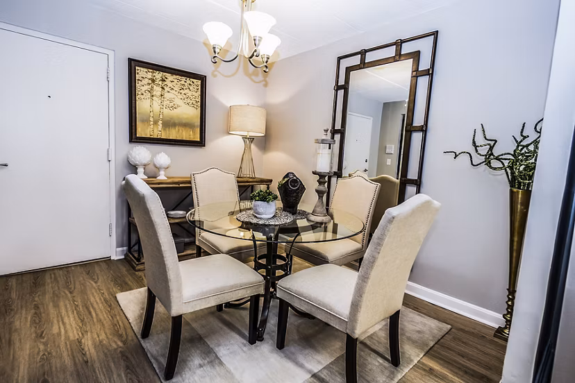 Dining room featuring modern decor and large windows at Avana Weymouth Apartments