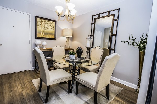 Dining room featuring modern decor and large windows at Avana Weymouth Apartments