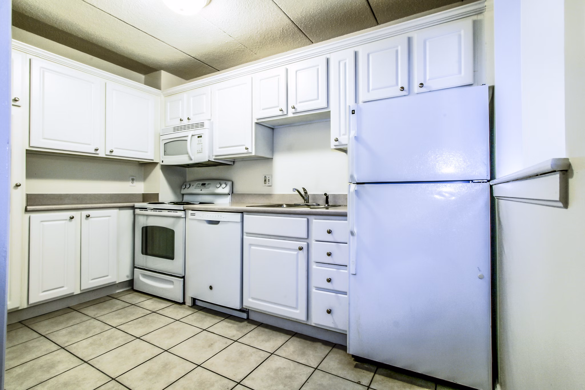 Modern kitchen with stainless steel appliances in Avana Weymouth Apartments