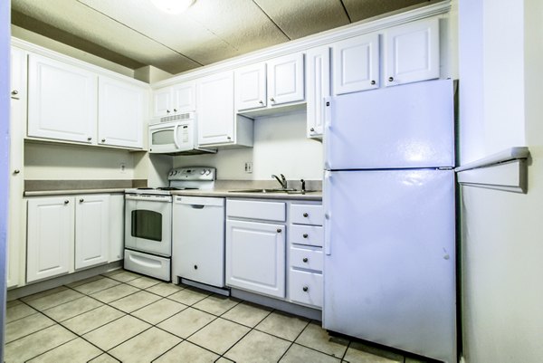 Modern kitchen with stainless steel appliances in Avana Weymouth Apartments