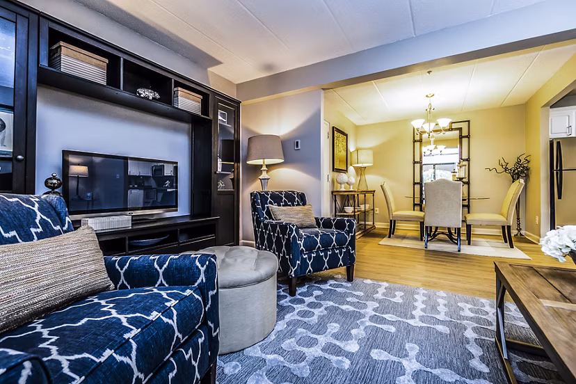 Spacious living room with natural light and modern furnishings in Avana Weymouth Apartments
