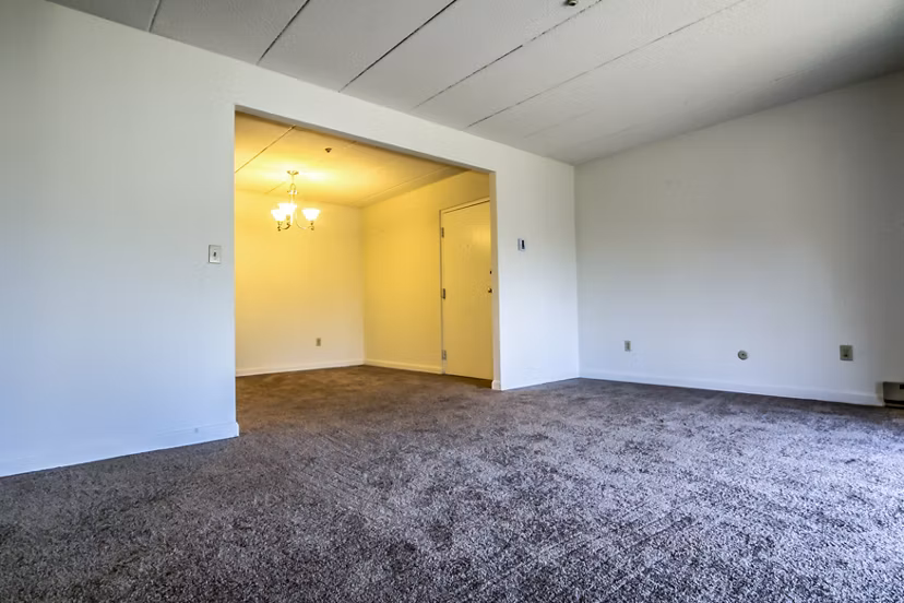 Spacious living room with modern decor and natural light in Avana Weymouth Apartments