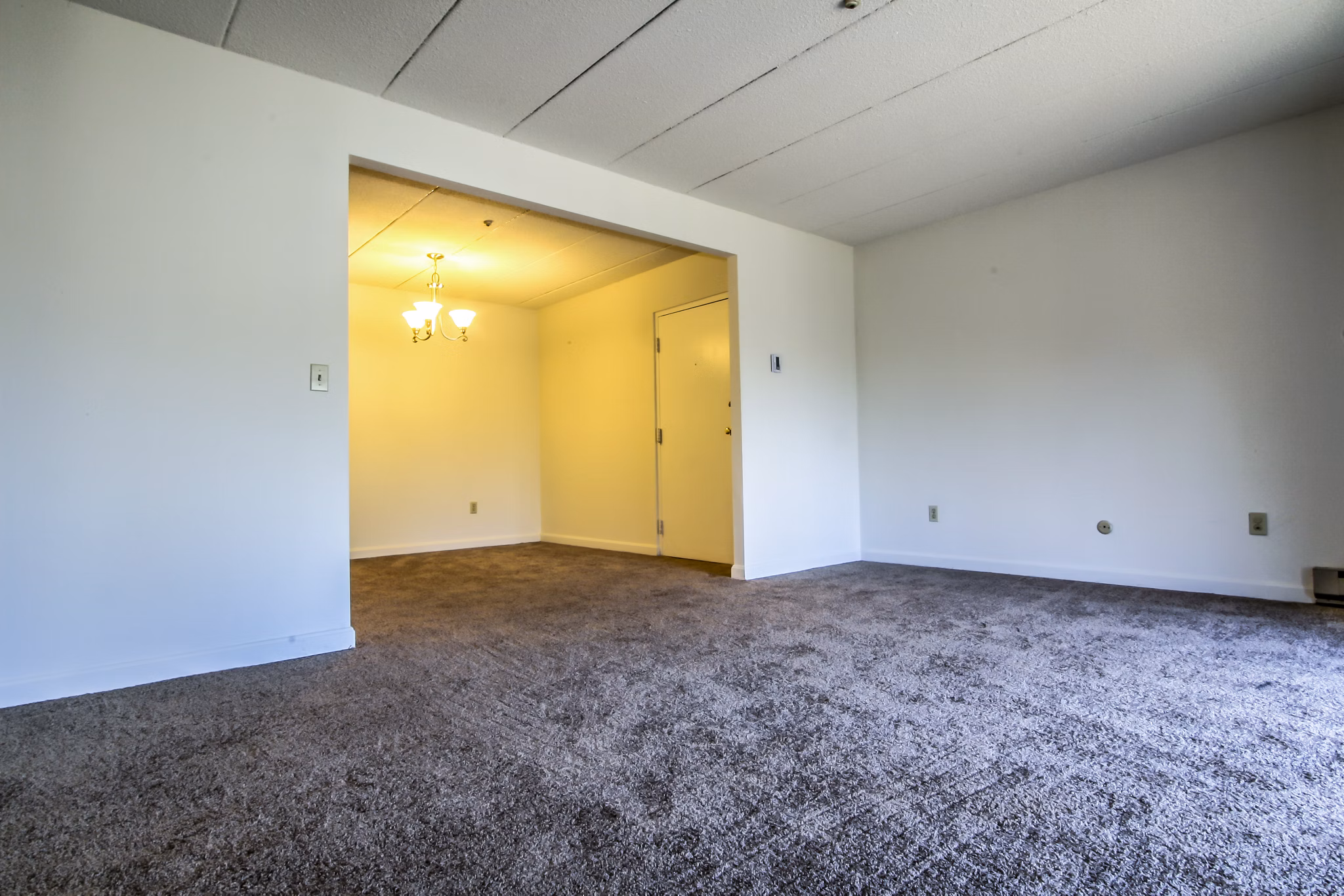 Spacious living room with modern decor and natural light in Avana Weymouth Apartments