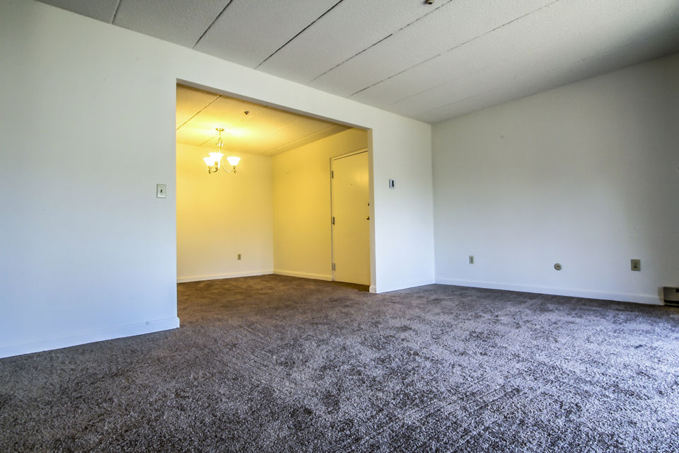 Spacious living room with modern decor and natural light in Avana Weymouth Apartments