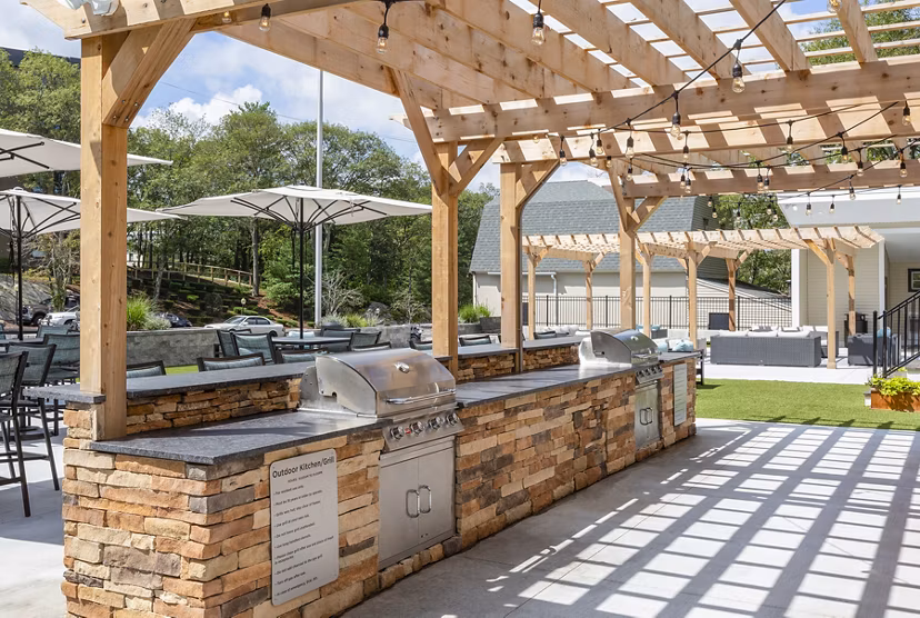 Grill area with modern seating at Avana Weymouth Apartments, perfect for outdoor dining and gatherings