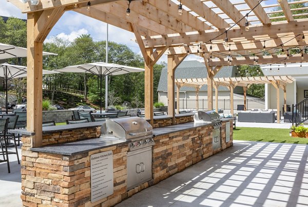 Grill area with modern seating at Avana Weymouth Apartments, perfect for outdoor dining and gatherings