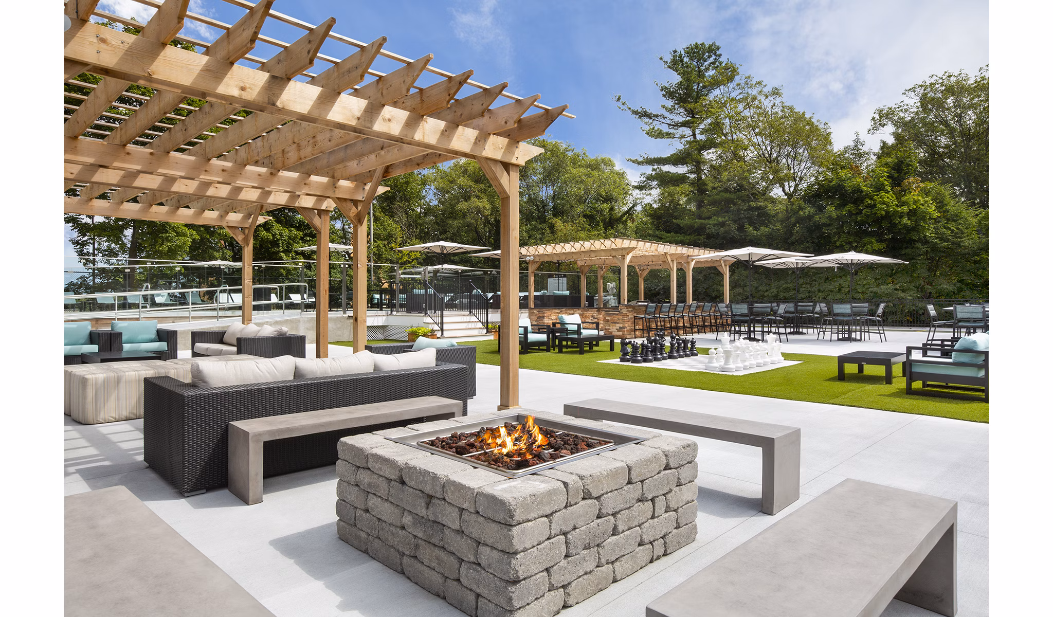 Cozy fire pit area at Avana Weymouth Apartments, perfect for social gatherings and relaxation