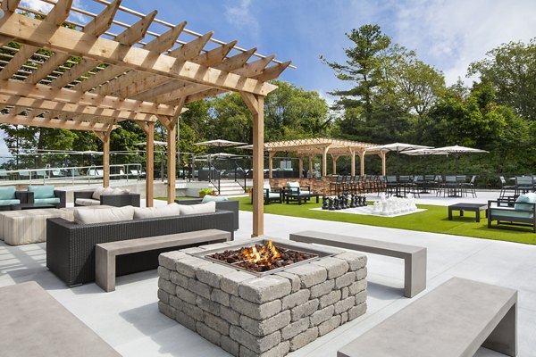 Cozy fire pit area at Avana Weymouth Apartments, perfect for social gatherings and relaxation