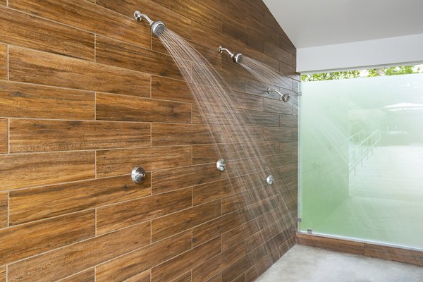 Modern pool showers at Avana Weymouth Apartments offering convenience and style