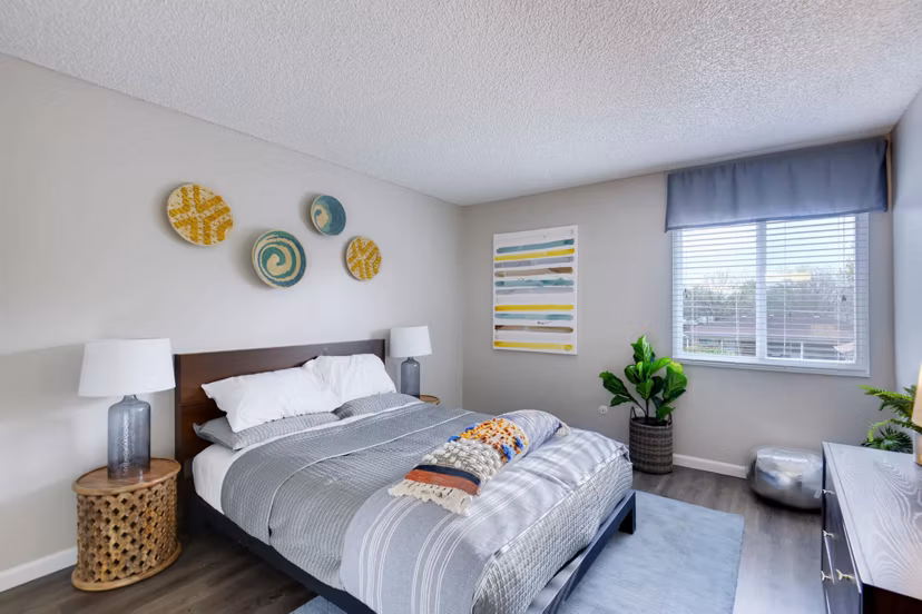 Cozy bedroom with modern furnishings at Park Place at 92nd Apartments