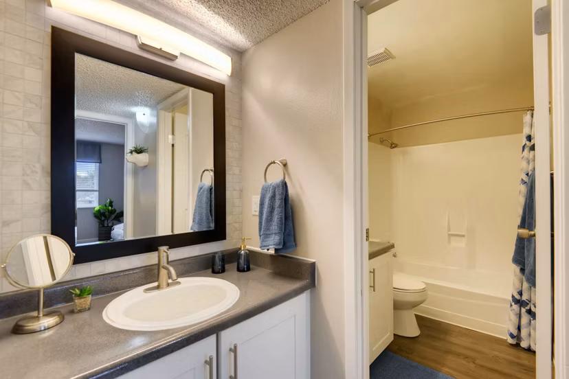 Bathroom with sleek fixtures and marble countertops in Park Place at 92nd Apartments