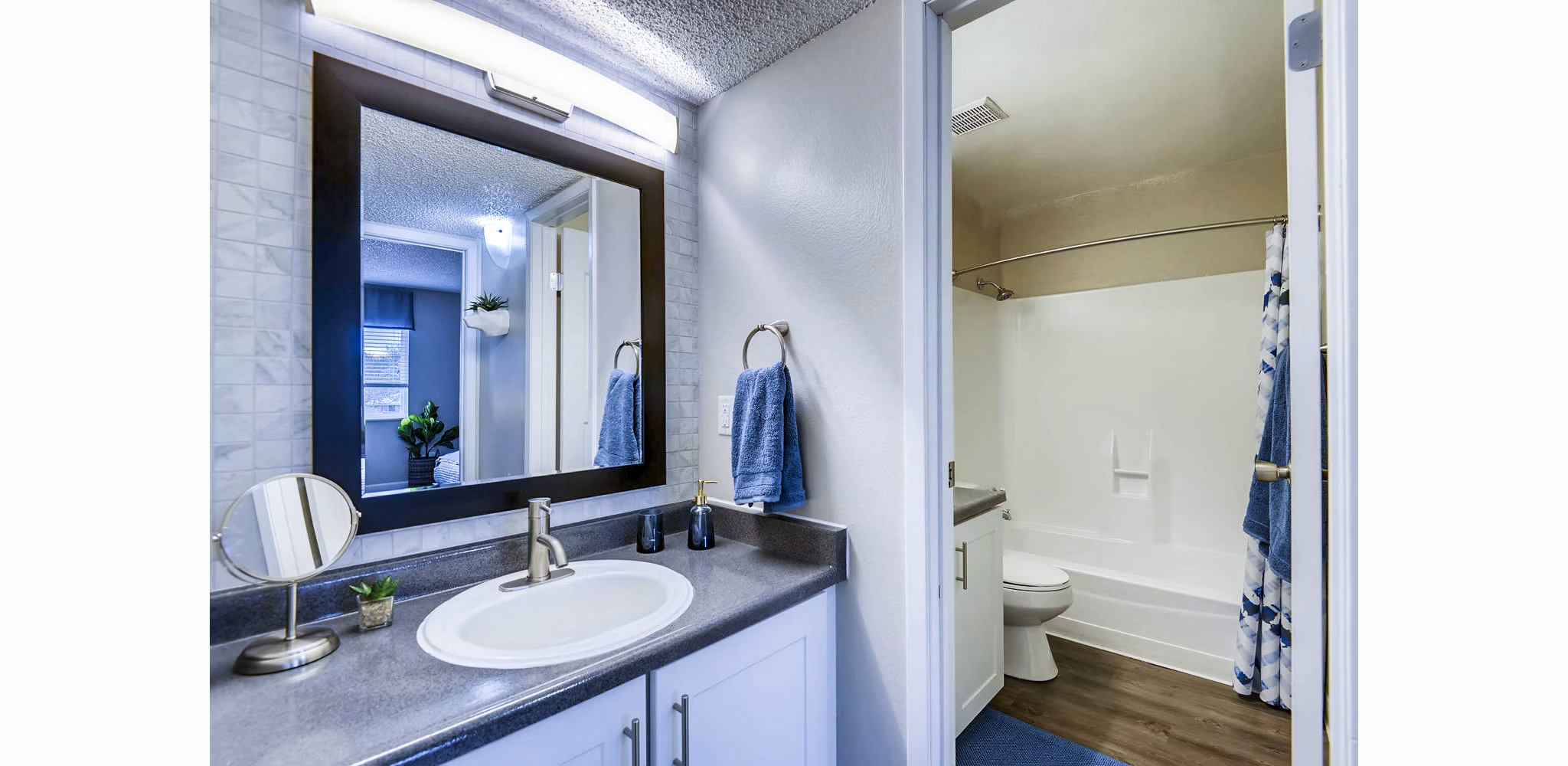 Bathroom with sleek fixtures and marble countertops in Park Place at 92nd Apartments