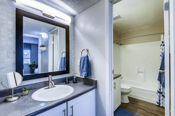 Bathroom with sleek fixtures and marble countertops in Park Place at 92nd Apartments